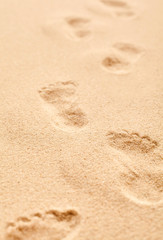 Fototapeta na wymiar Bare footprints receding away from the camera