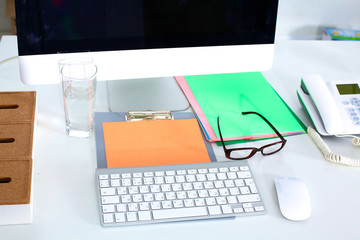 Designer working place with computer and paperwork