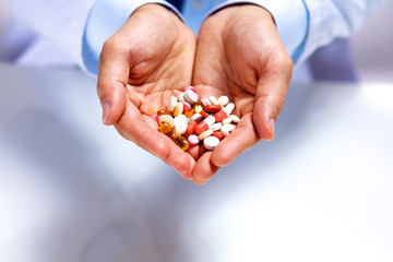 packing pills male doctor stretches in hand