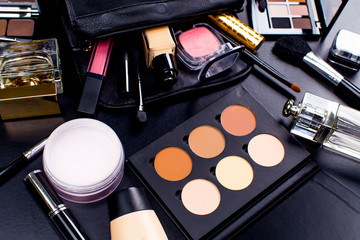 Cosmetics on dark background, closeup