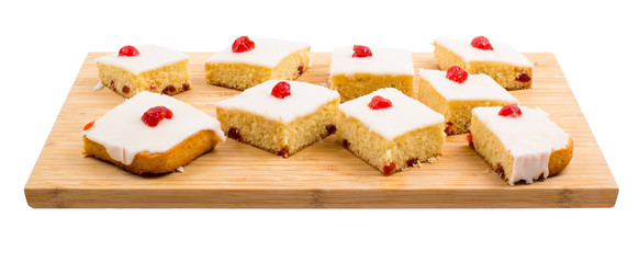 Square cake with cherry on