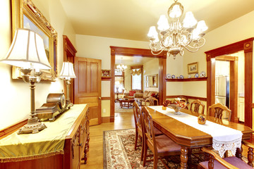Luxurious dining room with wood table chair set, chandelier and