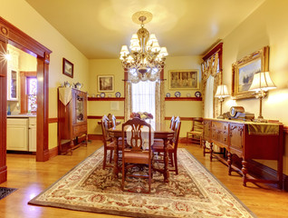 Luxurious dining room with wood table chair set, chandelier, vin