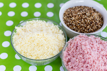 Grated yellow cheese, grated ham and baked sesame