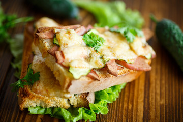 toast baked with sausage, cheese and cucumber