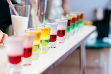 Colorful Liquor Shots with Alcohol In Cocktail Bar