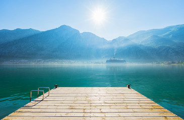 Early misty morning on the pier  with sea, Kotor city  and mountain views. Kotor bay. Montenegro