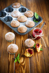Obraz na płótnie Canvas sweet baked muffins with jam inside