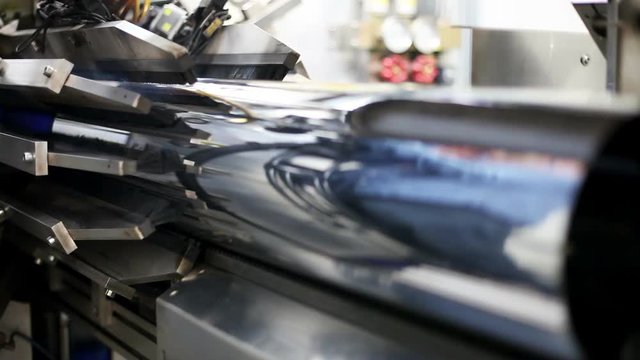 Manufacture of metal flues and ventilation systems. High-tech robotic line for the production of metal pipes. Inside view of the robotic complex. Timelapse footage of laser welding of joint