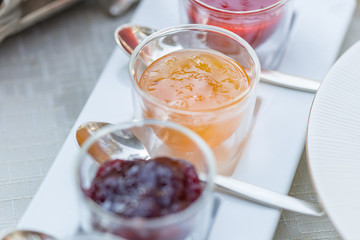 Different Berry Jam in Beautiful Glass Jars, Breakfast Time in Restaurant, Close-up
