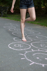 hopscotch, Young girl playing hopscotch 
