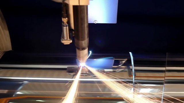 Manufacture of metal flues and ventilation systems. Laser machine cuts the metal pipe.