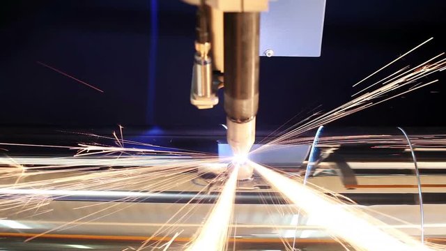 Manufacture of metal flues and ventilation systems. Laser machine cuts the metal pipe.