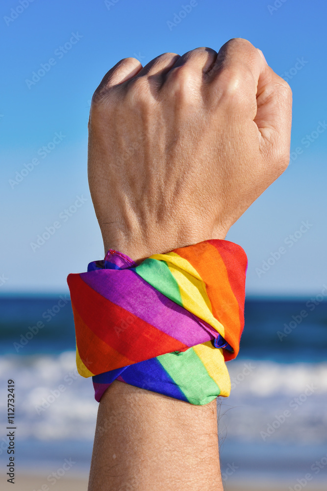 Poster man with a rainbow-patterned kerchief in his wrist