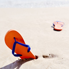 flip-flops on the sand of a beach