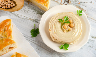 Plate of  a Creamy Hummus with pita and parsley.
