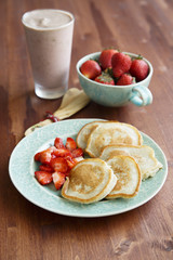 Vegan pancakes with banana and strawberry salad