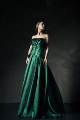 Model posing in green fashion dress
