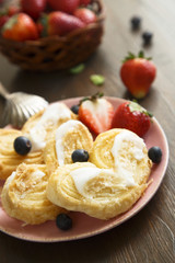 Puff pastry cookies with sugar glaze and berries