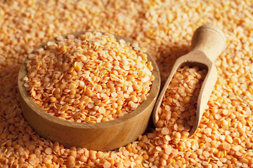 Red lentils, wooden scoop and bowl