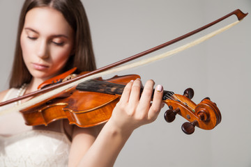 Close-up of woman playing violin with bow