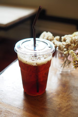 Iced Americano black coffee on a wooden table