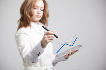Businesswoman working with growth graph on grey background