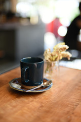 cup of coffee latte art on the wooden desk