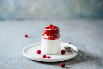 Cranberry with jam in whipped cream or yoghurt