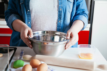 A Woman Cracking An Egg