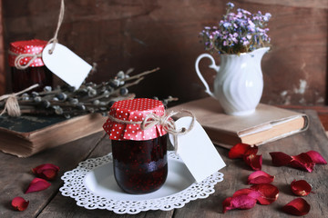 rustic homemade jam jar wooden background and flower