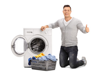 Guy doing laundry and giving thumb up