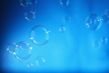 Rainbow soap bubbles on a blue backgrounds