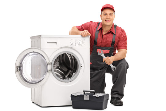 Repairman repairing a washing machine