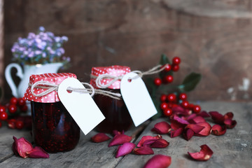 rustic homemade jam jar wooden background and flower