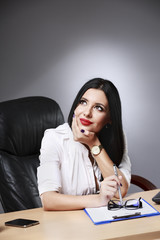 Adult young pretty business woman working at her office