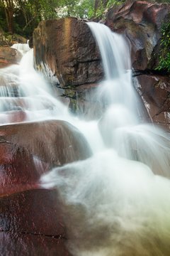 Waterfall and red rock