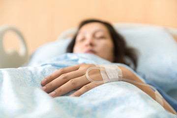 Patient is on a drip receiving a saline solution.