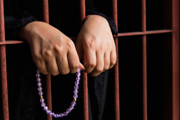 Muslim woman hand in jail