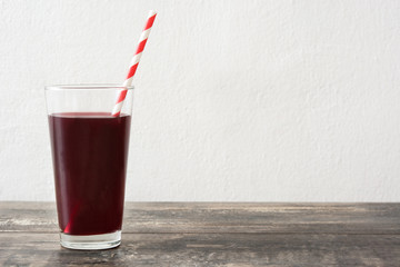 Berries smoothie in a glass on wood