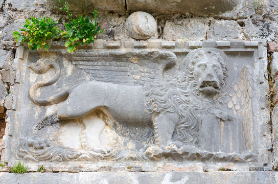Stone wall of ancient ruins with image of lion, Kotor