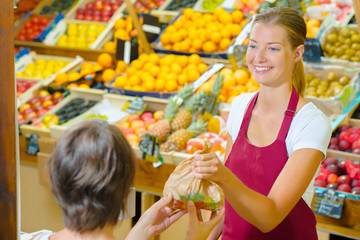 Greengrocer  serving a customer