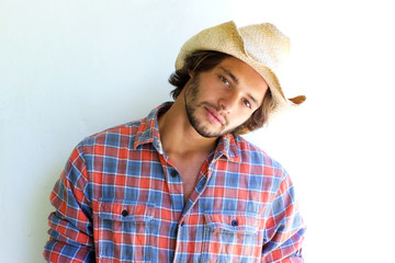 Rugged young man with plaid shirt and cowboy hat