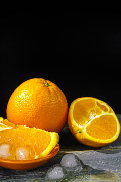 Fresh orange fruits and ice, hot summer concept