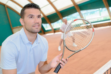 Men playing tennis match