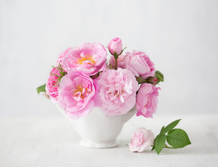 Obraz na płótnie Canvas Pink flowers (rose) on light grey background.