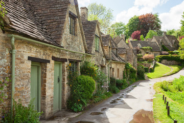 Fototapeta na wymiar Old street with traditional cottages in beautiful spring day , Bibury, England, UK.
