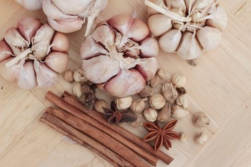 Garlic  has health benefits on wood background.
