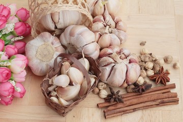 Garlic  has health benefits on wood background.