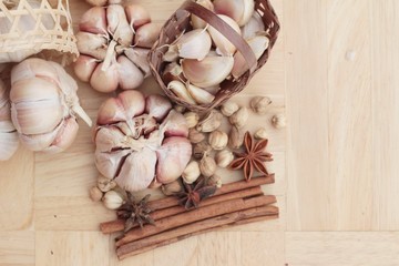 Garlic  has health benefits on wood background.